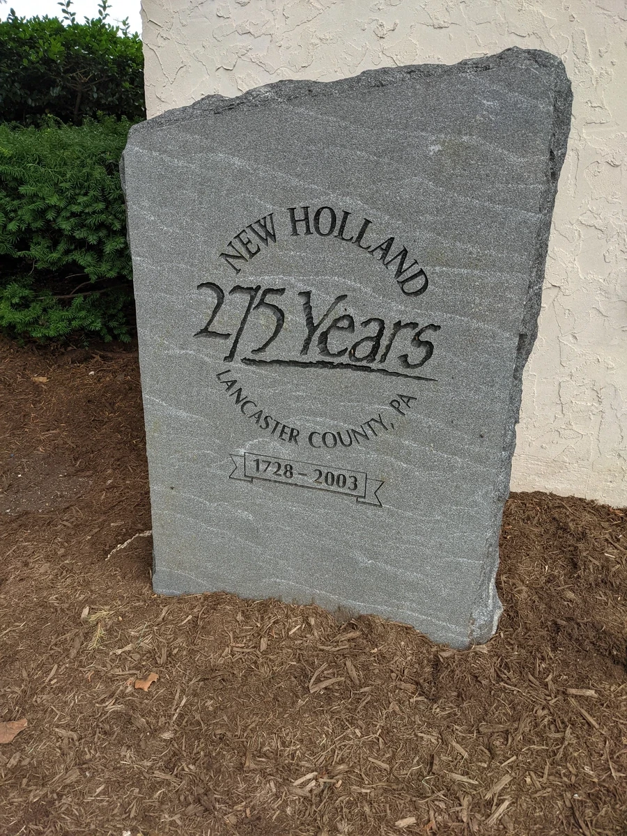 A stone marker engraved with the text 275 Years, New Holland, Lancaster County, PA. 1728 - 2003